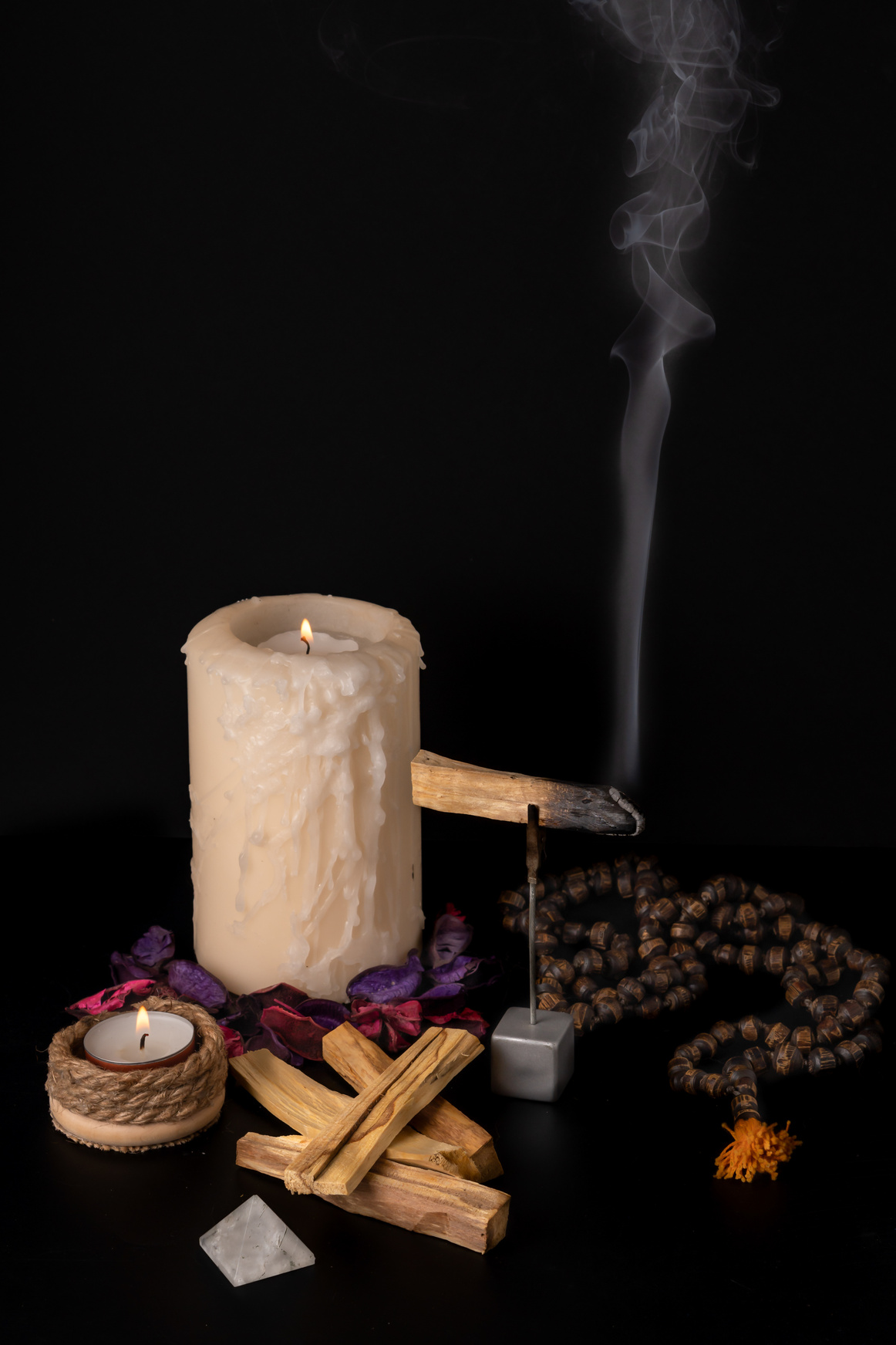 smoking palo santo ,holy stick with candles and japa-mala
